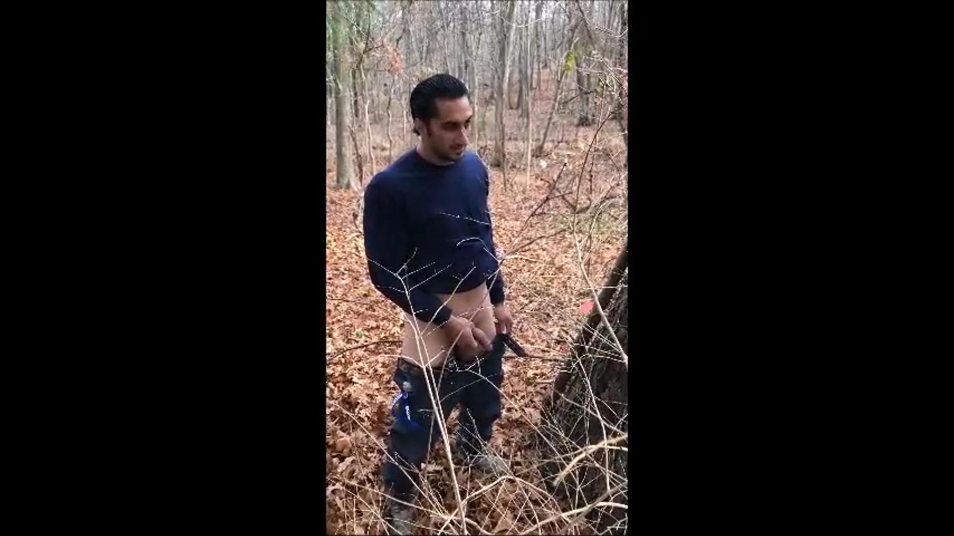 Guy peeing in the woods
